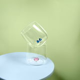 DRINKING GLASS WITH EMBOSSED BOW INSIDE THE GLASS