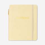 Butter yellow notebook with ballpoint pen