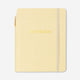 Butter yellow notebook with ballpoint pen