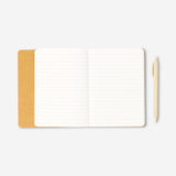 Butter yellow notebook with ballpoint pen