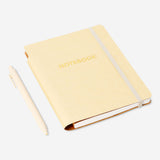 Butter yellow notebook with ballpoint pen