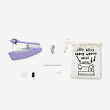 Purple handheld sewing machine