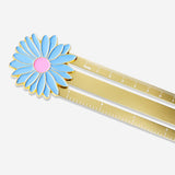 Gold metal ruler with flower